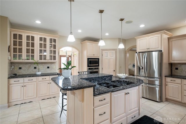 337 Yorkshire Ln, Beavercreek Twp, OH 45385 - kitchen with appliances with stainless steel finishes, light tile patterned flooring, glass insert cabinets, decorative backsplash, and recessed lighting