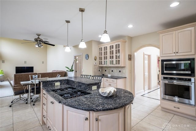 337 Yorkshire Ln, Beavercreek Twp, OH 45385 - kitchen with appliances with stainless steel finishes, cream cabinetry, light tile patterned floors, glass insert cabinets, and recessed lighting