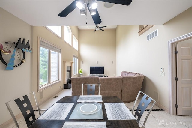 337 Yorkshire Ln, Beavercreek Twp, OH 45385 - dining area featuring ceiling fan, light tile patterned flooring, and a high ceiling