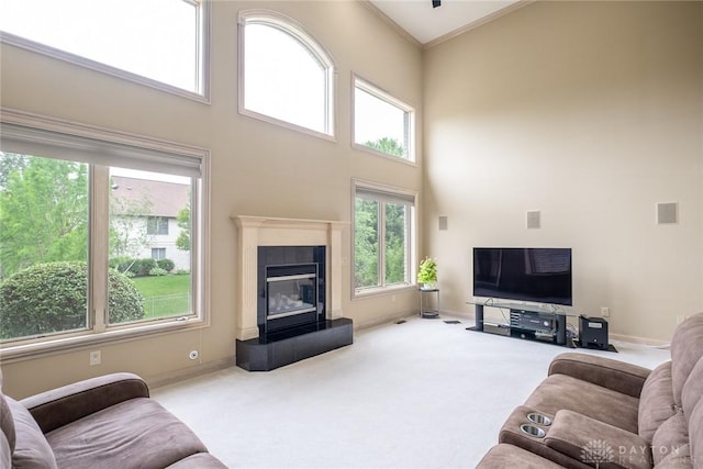 337 Yorkshire Ln, Beavercreek Twp, OH 45385 - living room with carpet flooring, healthy amount of natural light, a high ceiling, crown molding, and a glass covered fireplace