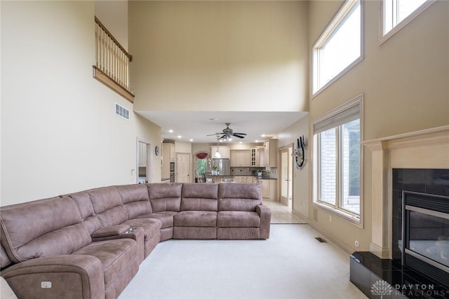 337 Yorkshire Ln, Beavercreek Twp, OH 45385 - living area with a high ceiling, a fireplace, light colored carpet, a ceiling fan, and recessed lighting