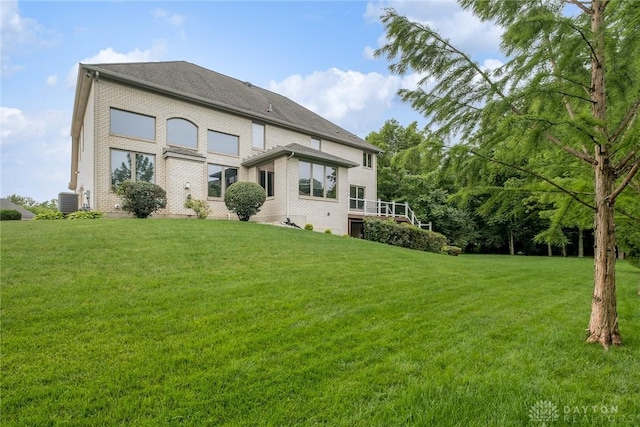 337 Yorkshire Ln, Beavercreek Twp, OH 45385 - back of property with a lawn and brick siding