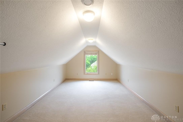 337 Yorkshire Ln, Beavercreek Twp, OH 45385 - additional living space with a textured ceiling, lofted ceiling, and carpet flooring