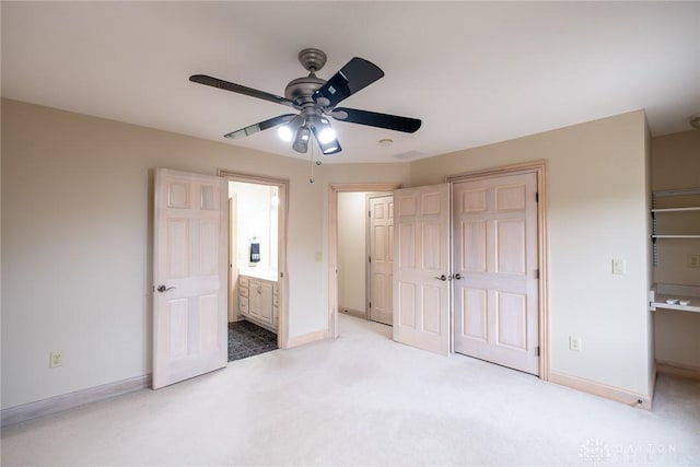 337 Yorkshire Ln, Beavercreek Twp, OH 45385 - unfurnished bedroom with light colored carpet, a closet, ensuite bathroom, and a ceiling fan