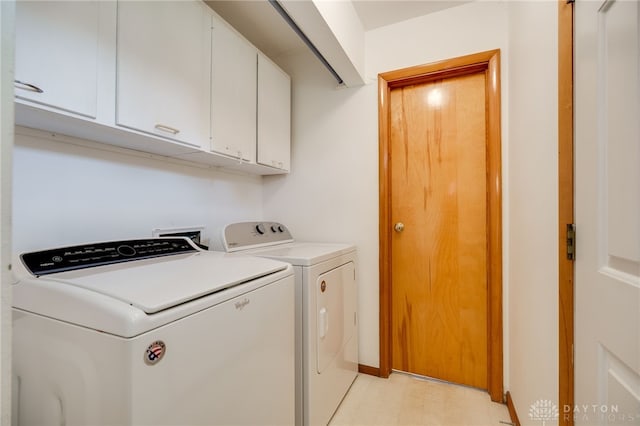 8866 Meadowlark Dr, Franklin, OH 45005 - washroom with washer and dryer, cabinet space, and light floors
