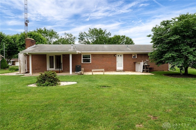 8866 Meadowlark Dr, Franklin, OH 45005 - rear view of house with a patio, a lawn, and brick siding