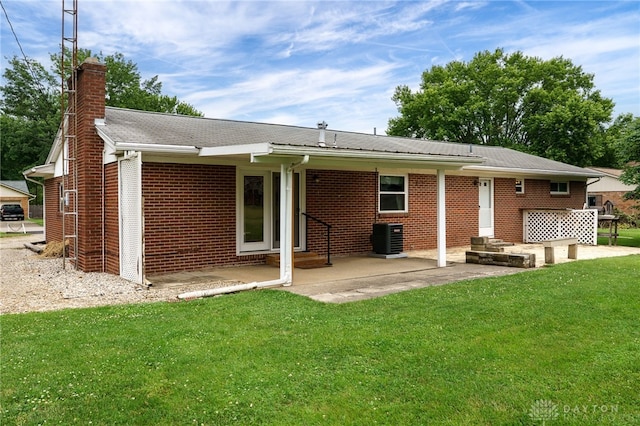 8866 Meadowlark Dr, Franklin, OH 45005 - rear view of house with a chimney, a yard, brick siding, and a patio
