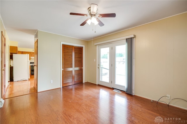 8866 Meadowlark Dr, Franklin, OH 45005 - unfurnished bedroom with freestanding refrigerator, access to outside, light wood-style floors, a closet, and ceiling fan