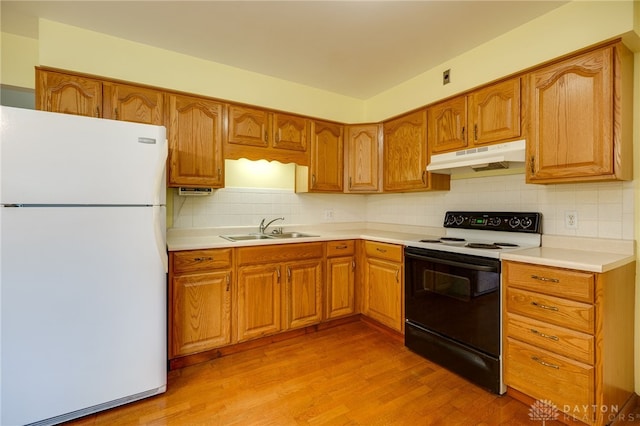 8866 Meadowlark Dr, Franklin, OH 45005 - kitchen with freestanding refrigerator, electric stove, under cabinet range hood, and light wood-style floors