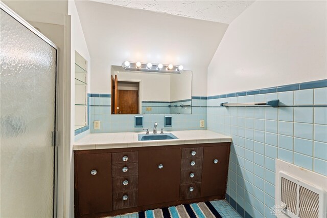 405 Hyde Park Dr, Hamilton, OH 45013 - full bathroom featuring tile walls, vanity, a shower stall, wainscoting, and lofted ceiling