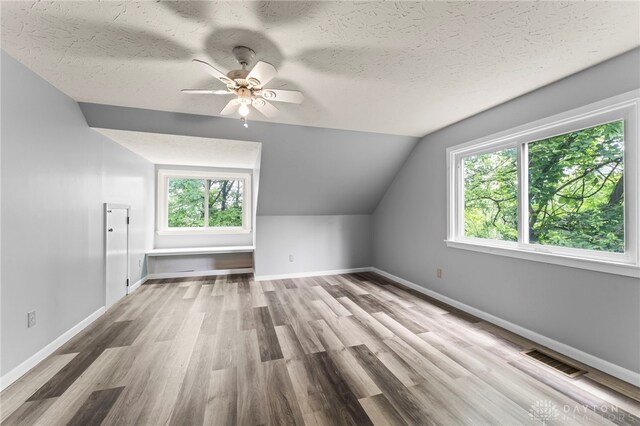 405 Hyde Park Dr, Hamilton, OH 45013 - bonus room featuring wood finished floors, lofted ceiling, a ceiling fan, and a textured ceiling