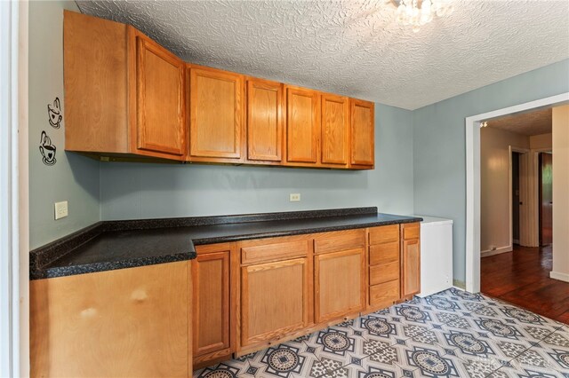 405 Hyde Park Dr, Hamilton, OH 45013 - kitchen with dark countertops and brown cabinets