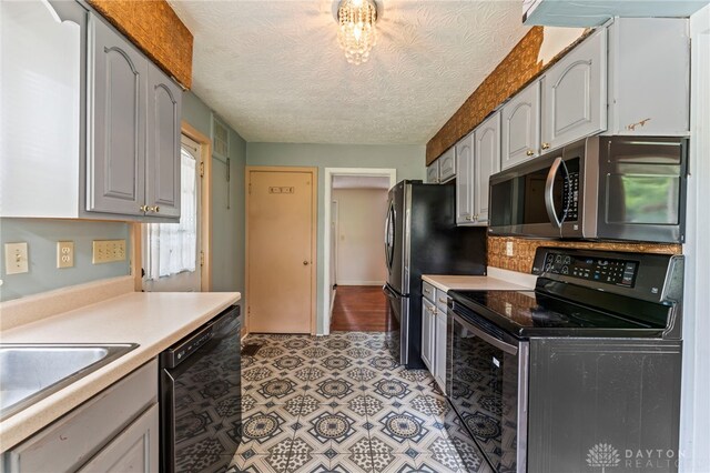 405 Hyde Park Dr, Hamilton, OH 45013 - kitchen with black appliances, light countertops, backsplash, and a textured ceiling