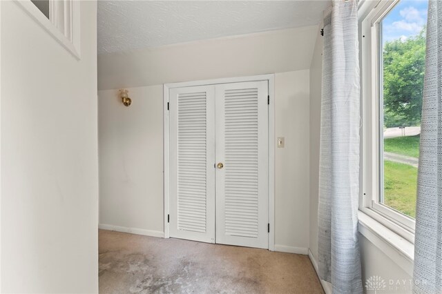 405 Hyde Park Dr, Hamilton, OH 45013 - unfurnished bedroom featuring carpet flooring, multiple windows, and a closet
