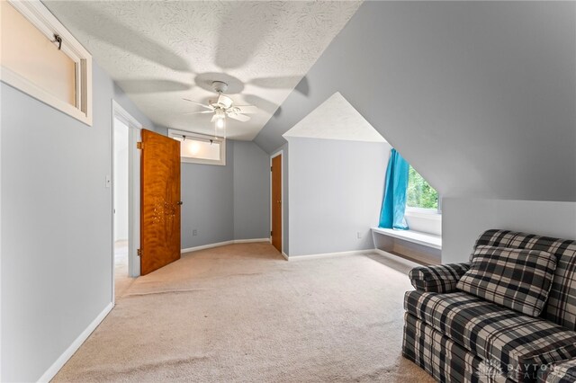 405 Hyde Park Dr, Hamilton, OH 45013 - sitting room with carpet flooring, ceiling fan, vaulted ceiling, and a textured ceiling