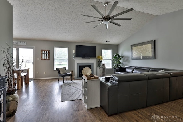 11 Green Meadow Ct, Franklin, OH 45005 - living area featuring a fireplace with raised hearth, a ceiling fan, a textured ceiling, dark wood-style floors, and vaulted ceiling