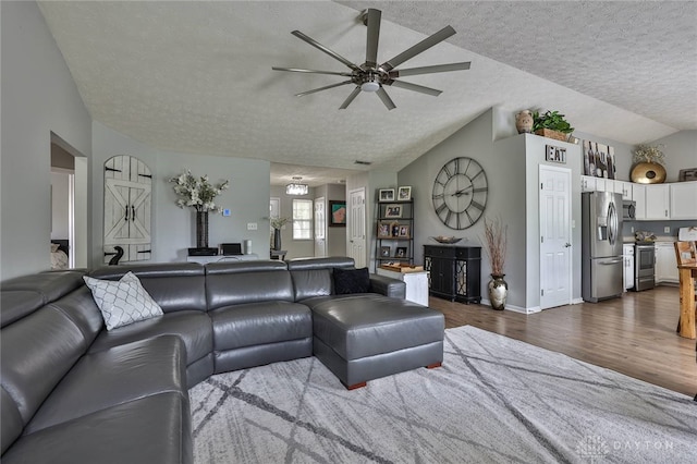 11 Green Meadow Ct, Franklin, OH 45005 - living room with ceiling fan, a textured ceiling, dark wood-style floors, and vaulted ceiling