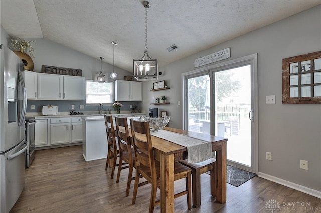11 Green Meadow Ct, Franklin, OH 45005 - dining area with lofted ceiling, dark wood-type flooring, a textured ceiling, and a chandelier