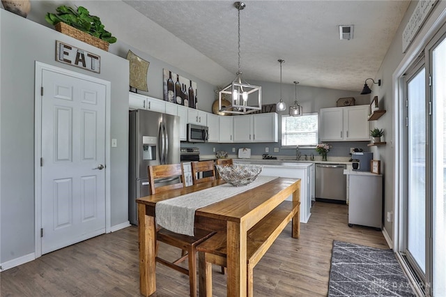 11 Green Meadow Ct, Franklin, OH 45005 - kitchen with appliances with stainless steel finishes, lofted ceiling, white cabinets, a chandelier, and light wood-style floors