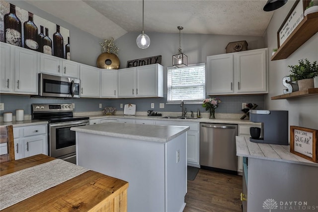 11 Green Meadow Ct, Franklin, OH 45005 - kitchen with stainless steel appliances, lofted ceiling, white cabinetry, light countertops, and hanging light fixtures