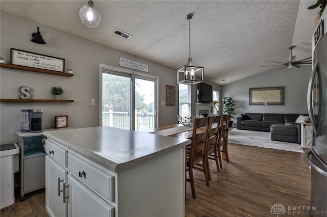 11 Green Meadow Ct, Franklin, OH 45005 - kitchen featuring a textured ceiling, stainless steel fridge, dark wood finished floors, white cabinetry, and lofted ceiling