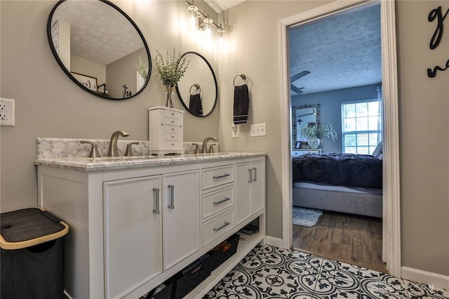 11 Green Meadow Ct, Franklin, OH 45005 - ensuite bathroom with a textured ceiling, double vanity, and wood finished floors