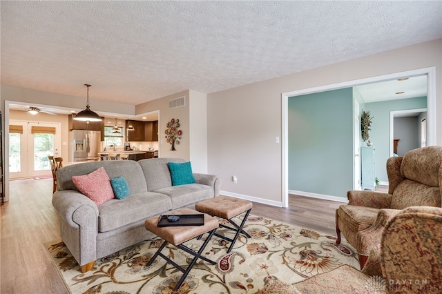 9256 Amchar Ct, Dayton, OH 45458 - living room with light wood-type flooring, a textured ceiling, and a ceiling fan