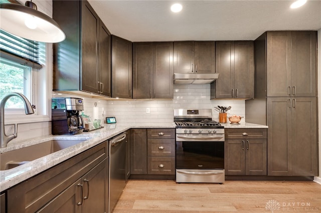 9256 Amchar Ct, Dayton, OH 45458 - kitchen with appliances with stainless steel finishes, under cabinet range hood, light wood finished floors, dark brown cabinetry, and recessed lighting