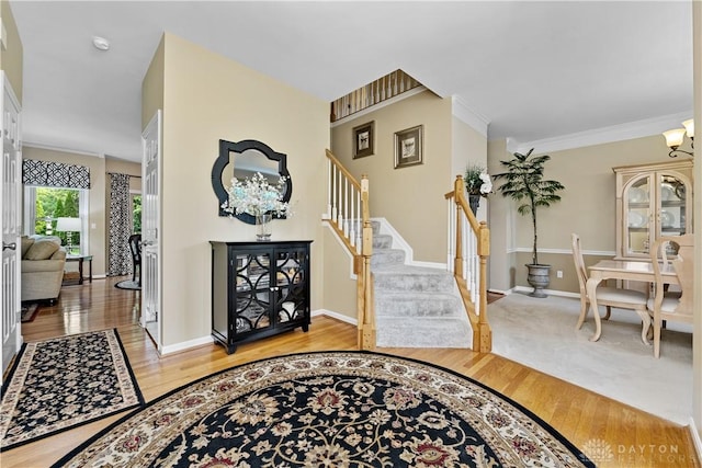 1027 W Bridlepath Ln, Miami Twp, OH 45140 - foyer featuring light wood-type flooring, stairway, and ornamental molding
