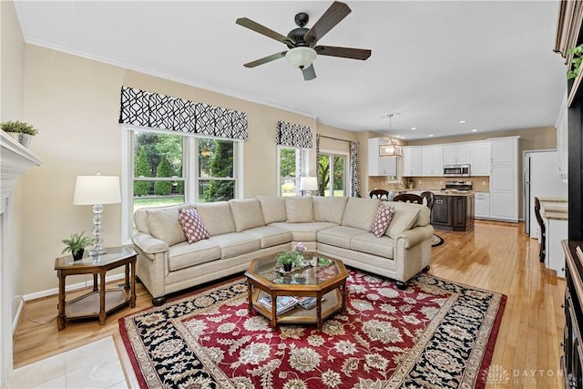 1027 W Bridlepath Ln, Miami Twp, OH 45140 - living area featuring a ceiling fan, recessed lighting, light wood finished floors, ornamental molding, and a fireplace
