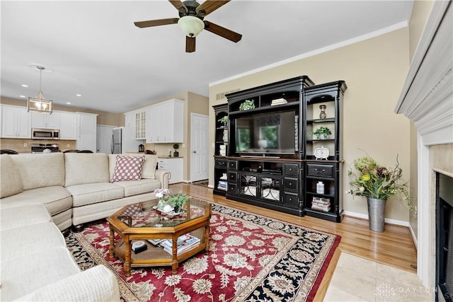 1027 W Bridlepath Ln, Miami Twp, OH 45140 - living room with ceiling fan, light wood-style floors, recessed lighting, and crown molding