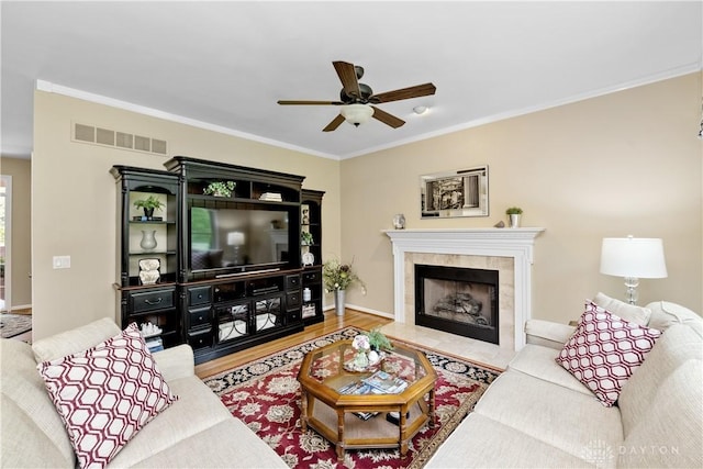 1027 W Bridlepath Ln, Miami Twp, OH 45140 - living area featuring ceiling fan, wood finished floors, ornamental molding, and a fireplace