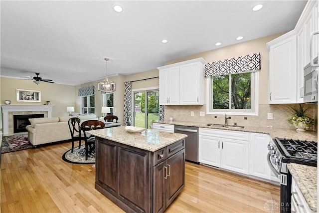 1027 W Bridlepath Ln, Miami Twp, OH 45140 - kitchen with stainless steel appliances, white cabinets, dark brown cabinetry, ceiling fan, and recessed lighting