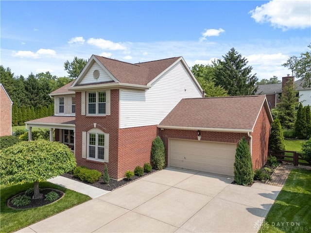 1027 W Bridlepath Ln, Miami Twp, OH 45140 - view of front facade featuring an attached garage, driveway, brick siding, and a shingled roof