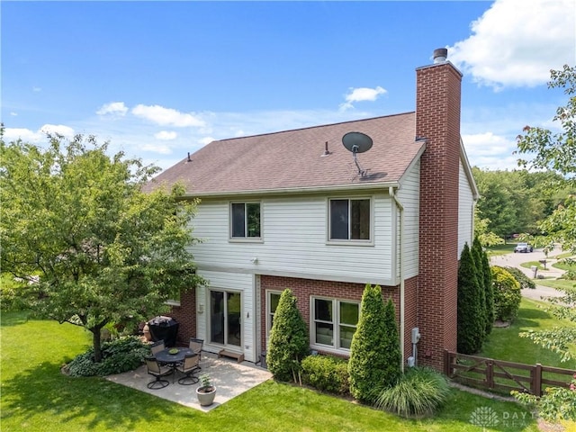 1027 W Bridlepath Ln, Miami Twp, OH 45140 - back of property featuring a patio area, a chimney, brick siding, and a shingled roof