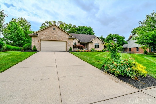 2690 Langtree Ln, Washington Twp, OH 45458 - single story home with a front lawn, a garage, driveway, and brick siding