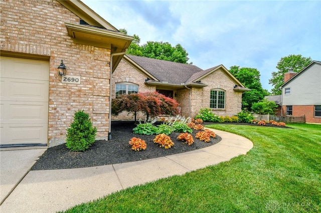 2690 Langtree Ln, Washington Twp, OH 45458 - view of front facade featuring a front lawn and brick siding