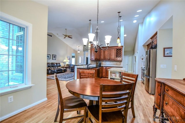 2690 Langtree Ln, Washington Twp, OH 45458 - dining space with light wood-style floors, a chandelier, ceiling fan, and lofted ceiling