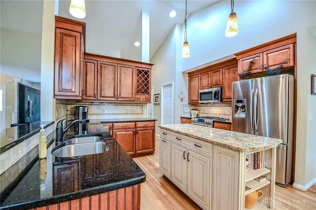 2690 Langtree Ln, Washington Twp, OH 45458 - kitchen with stainless steel appliances, light wood-type flooring, decorative backsplash, open shelves, and dark stone countertops