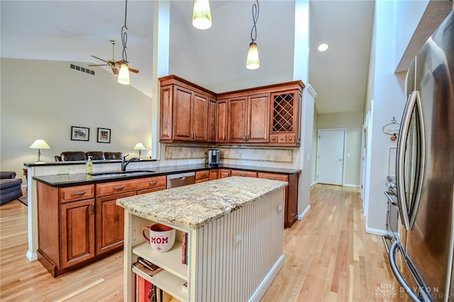 2690 Langtree Ln, Washington Twp, OH 45458 - kitchen with stainless steel appliances, vaulted ceiling, open floor plan, light wood-style floors, and a ceiling fan