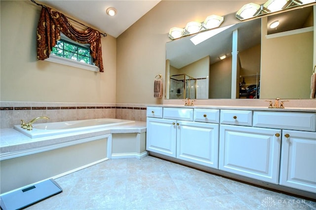 2690 Langtree Ln, Washington Twp, OH 45458 - full bath with lofted ceiling, a garden tub, a stall shower, double vanity, and tile patterned floors