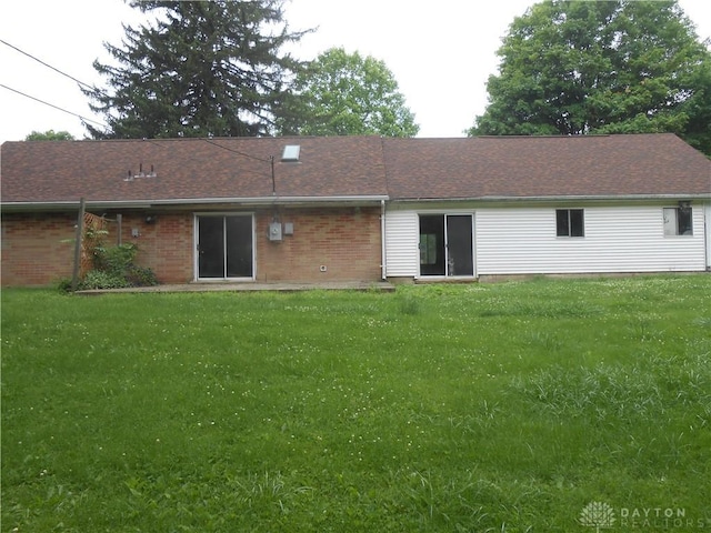 9705 E Haskett Ln, Bethel Twp, OH 45424 - back of house with a yard and brick siding