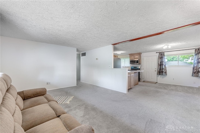 4501 Hannaford St, Miami Twp, OH 45439 - living room featuring light colored carpet and a textured ceiling