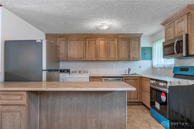 4501 Hannaford St, Miami Twp, OH 45439 - kitchen with stainless steel appliances, independent washer and dryer, light countertops, decorative backsplash, and electric panel