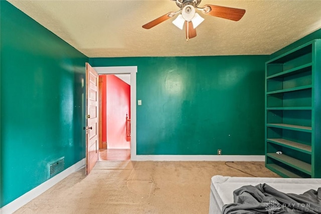 2311 S Dixie Dr, Kettering, OH 45409 - unfurnished bedroom with a textured ceiling, carpet, and ceiling fan