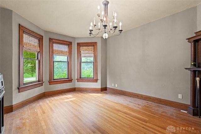 2311 S Dixie Dr, Kettering, OH 45409 - unfurnished dining area with light wood-style floors and a chandelier