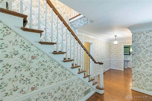 1919 Tait Circle Rd, Kettering, OH 45429 - staircase featuring wallpapered walls, ornamental molding, and wood finished floors