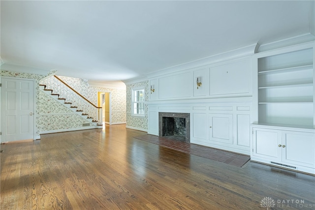 1919 Tait Circle Rd, Kettering, OH 45429 - unfurnished living room with wallpapered walls, stairway, ornamental molding, a premium fireplace, and wood finished floors