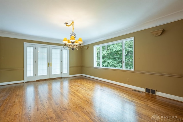 1919 Tait Circle Rd, Kettering, OH 45429 - spare room with a chandelier, ornamental molding, and wood finished floors