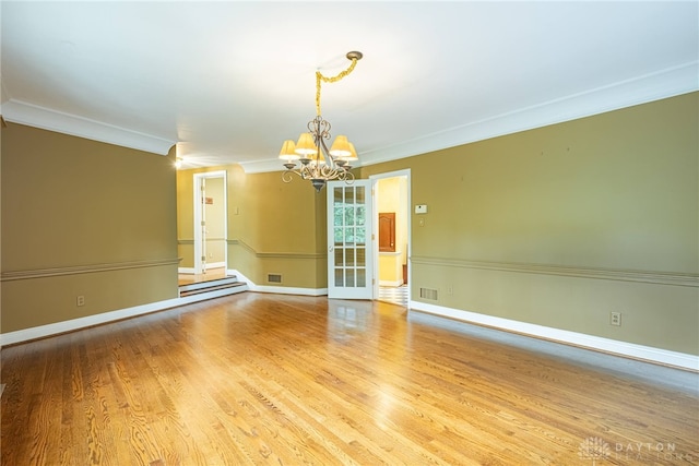 1919 Tait Circle Rd, Kettering, OH 45429 - empty room featuring a chandelier, ornamental molding, and wood finished floors
